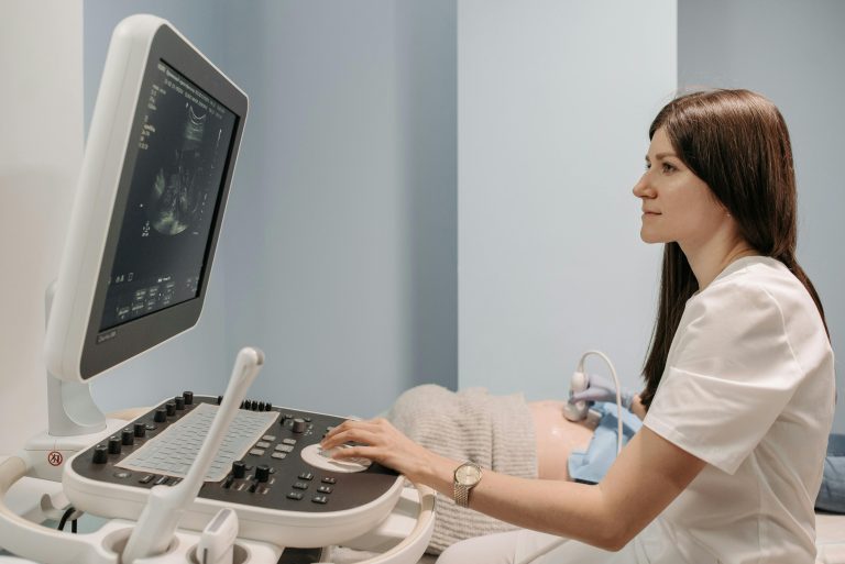 A female doctor conducting an ultrasound examination in a medical clinic, focusing on patient care.